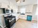 Modern kitchen features stainless steel appliances, white cabinetry, and a stylish gas range stove at 3008 Nichol Ave, Anderson, IN 46011