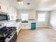 Updated kitchen features stainless steel appliances, white cabinets, and contrasting black hardware at 3008 Nichol Ave, Anderson, IN 46011