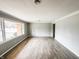 Sunlit living room features wood floors, fresh paint, and ample natural light from large windows at 3008 Nichol Ave, Anderson, IN 46011