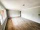 Bright, open living room with new hardwood flooring and fresh gray paint at 3008 Nichol Ave, Anderson, IN 46011