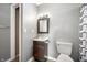 Bathroom with mirror and sink, toilet, and shower with curtain at 3225 S Rybolt Ave, Indianapolis, IN 46221