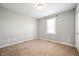 Bedroom featuring a window and neutral colored walls and carpet at 3225 S Rybolt Ave, Indianapolis, IN 46221