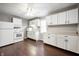 Kitchen featuring white cabinets and appliances, with hardwood floor at 3225 S Rybolt Ave, Indianapolis, IN 46221