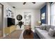 View of the staged living room with hardwood floors, a gray sofa and neutral paint at 3225 S Rybolt Ave, Indianapolis, IN 46221