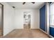 Living room with a blue accent wall, ceiling fan, window and neutral carpet at 3225 S Rybolt Ave, Indianapolis, IN 46221