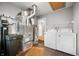 Utility room includes a washer, dryer, and large water filtration system at 3225 S Rybolt Ave, Indianapolis, IN 46221