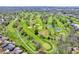 A picturesque aerial shot captures the vibrant green fairways of the community golf course at 3559 Towne Dr, Carmel, IN 46032