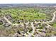 An aerial view shows lovely homes surrounding a lush golf course in a suburban community at 3559 Towne Dr, Carmel, IN 46032