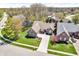 Aerial view of a brick home with a large driveway and well-maintained landscaping at 3559 Towne Dr, Carmel, IN 46032