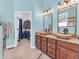 Bathroom with dual vessel sinks, granite counters, and a view into the walk-in closet at 3559 Towne Dr, Carmel, IN 46032