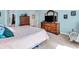 Bedroom with a large bed, wooden dressers, and serene blue walls at 3559 Towne Dr, Carmel, IN 46032