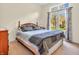 Cozy bedroom featuring a comfortable bed with decorative pillows and soft carpeting, with natural light at 3559 Towne Dr, Carmel, IN 46032