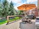 Inviting deck with an umbrella, comfortable seating and view of the well-manicured backyard at 3559 Towne Dr, Carmel, IN 46032