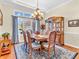 Formal dining room featuring a chandelier, hardwood floors, and a view of the front yard at 3559 Towne Dr, Carmel, IN 46032