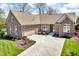 Beautiful brick home with a well-manicured lawn and a circular driveway and two car garage at 3559 Towne Dr, Carmel, IN 46032