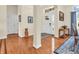 Inviting foyer featuring a white front door with glass, warm wood floors and an archway leading to other rooms at 3559 Towne Dr, Carmel, IN 46032