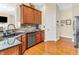 Gourmet kitchen with wooden cabinets, granite countertops, and stainless steel appliances, next to hardwood floors at 3559 Towne Dr, Carmel, IN 46032