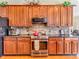 Modern kitchen with stainless steel appliances, wooden cabinets, and granite countertops with backsplash for cooking at 3559 Towne Dr, Carmel, IN 46032