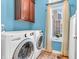 Functional laundry room equipped with modern washer and dryer, plus overhead cabinetry for storage at 3559 Towne Dr, Carmel, IN 46032