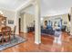 Open-concept living room and dining area with hardwood floors and elegant furnishings at 3559 Towne Dr, Carmel, IN 46032