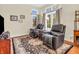 Cozy living area with leather recliners, a decorative rug, and plenty of natural light at 3559 Towne Dr, Carmel, IN 46032