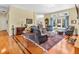 Cozy living room featuring hardwood floors, ample seating, and natural light from a large window at 3559 Towne Dr, Carmel, IN 46032