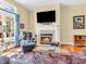 Living room boasts a cozy fireplace, large window with natural light, and comfortable seating with a decorative rug at 3559 Towne Dr, Carmel, IN 46032