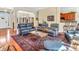 Spacious living room with open layout, fireplace and hardwood floors, seamlessly connected to kitchen and dining area at 3559 Towne Dr, Carmel, IN 46032