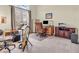 Bright home office with large window, desk, cabinets, and music equipment offering a versatile workspace at 3559 Towne Dr, Carmel, IN 46032
