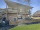 The spacious backyard features a deck, patio, and lush greenery at 3736 W South Wood Lake Dr, Columbus, IN 47201