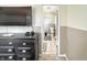 View into a quaint half bathroom with wainscotting, tile flooring, and neutral color palette at 3736 W South Wood Lake Dr, Columbus, IN 47201