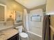 Cozy bathroom showcasing a tub with shower, granite countertop, and built-in storage at 3736 W South Wood Lake Dr, Columbus, IN 47201