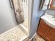 Bathroom featuring a unique stone floor in the shower, and wood cabinets at 3736 W South Wood Lake Dr, Columbus, IN 47201