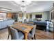 Open-concept dining area features modern chandelier, dining table, and access to kitchen and living area at 3736 W South Wood Lake Dr, Columbus, IN 47201