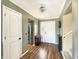 Welcoming foyer with beautiful lighting and kitchen in the background at 3736 W South Wood Lake Dr, Columbus, IN 47201