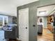 A doorway view of the kitchen features wood floors, cabinetry, and an island with metal siding at 3736 W South Wood Lake Dr, Columbus, IN 47201