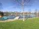 Peaceful waterfront scene with a dock and pedal boat, surrounded by lush greenery at 3736 W South Wood Lake Dr, Columbus, IN 47201