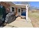 Charming covered back porch with seating area, grill, and serene backyard view at 425 Conduitt Dr, Mooresville, IN 46158