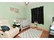 Cozy Bedroom with a crib, recliner, and calming decor at 425 Conduitt Dr, Mooresville, IN 46158