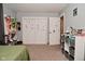 Bedroom with carpet, pegboard wall organizer, and closet with sliding doors at 425 Conduitt Dr, Mooresville, IN 46158