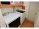 Laundry room featuring white washer and dryer and wood laminate floors at 425 Conduitt Dr, Mooresville, IN 46158