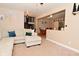 Spacious living room with an L-shaped sofa, open staircase, and view into the dining area at 425 Conduitt Dr, Mooresville, IN 46158