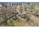 Aerial view of a well-maintained home with a detached garage, surrounded by a spacious lawn and mature trees at 4709 S County Road 500 E, Plainfield, IN 46168