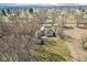 Aerial view of a charming home featuring a spacious yard, mature trees, and serene surroundings at 4709 S County Road 500 E, Plainfield, IN 46168