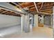 Basement features an exposed ceiling and painted floors at 4709 S County Road 500 E, Plainfield, IN 46168
