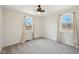 Bright bedroom featuring neutral paint, carpet, and two windows at 4709 S County Road 500 E, Plainfield, IN 46168