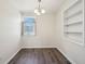 Dining room with wood-look floors, window, and built-in shelving at 4709 S County Road 500 E, Plainfield, IN 46168