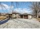 Full view of the home featuring a detached two-car garage and gravel driveway at 4709 S County Road 500 E, Plainfield, IN 46168
