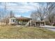 Quaint home with a cozy front porch and a detached two-car garage, surrounded by mature trees in a serene setting at 4709 S County Road 500 E, Plainfield, IN 46168