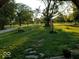 Expansive front yard featuring lush green grass and mature trees, creating a serene and inviting atmosphere at 4709 S County Road 500 E, Plainfield, IN 46168